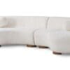 Contemporary curved sectional sofa in off-white fabric, featuring playful design and cozy comfort.