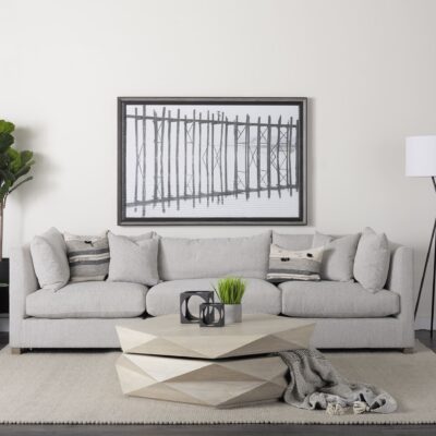 Stylish contemporary living room featuring a light gray sofa and unique geometric coffee table.