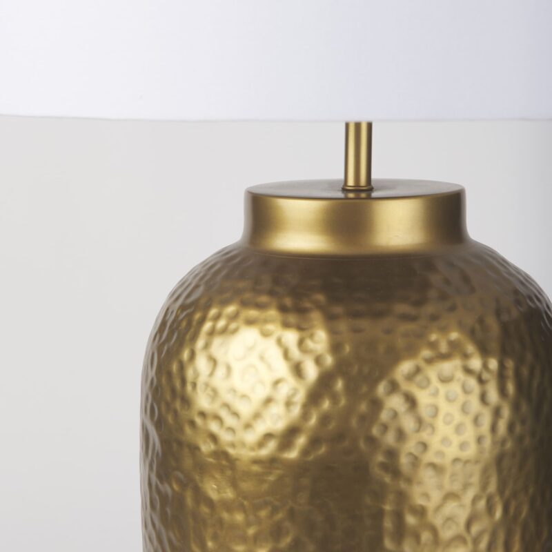 Elegant gold hammered metal lamp with white shade, perfect for enhancing any interior decor.