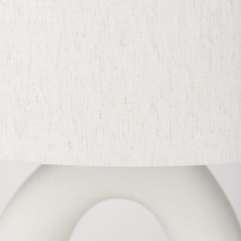 Contemporary lamp featuring a textured shade and sleek, minimalist base for elegant decor.