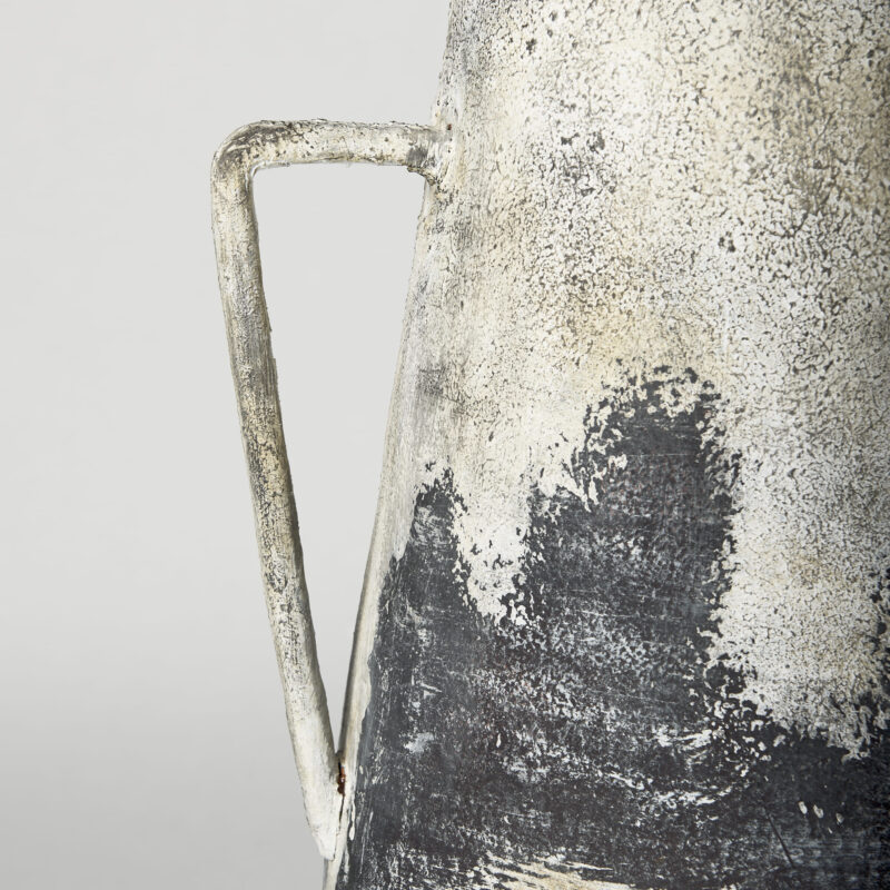 Unique sculptural vessel featuring textured surfaces and earthy tones for modern decor.