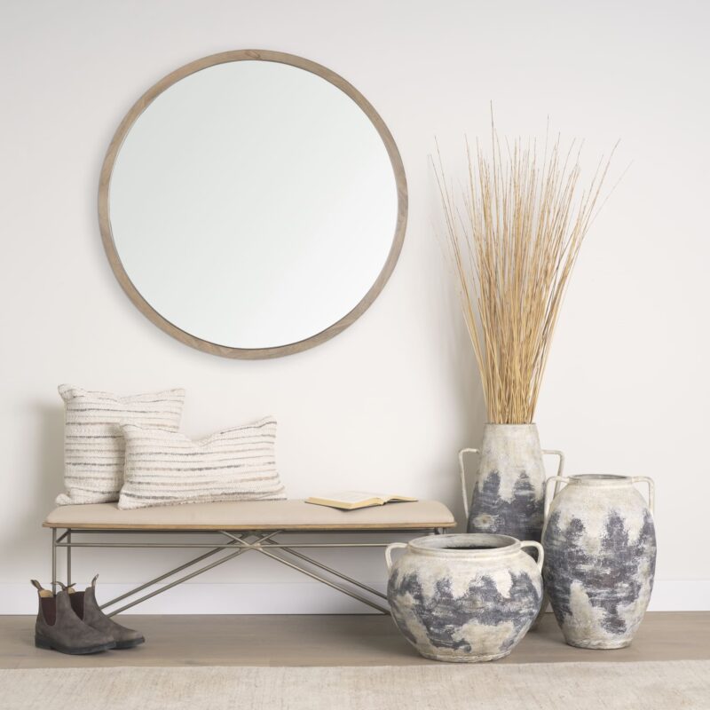 Chic corner decor with minimalist bench, vases, and natural elements for modern elegance.