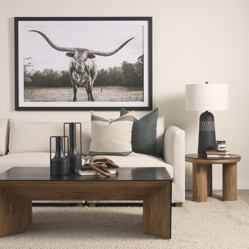 Stylish living room featuring longhorn steer artwork, cozy sofa, and modern decor elements.