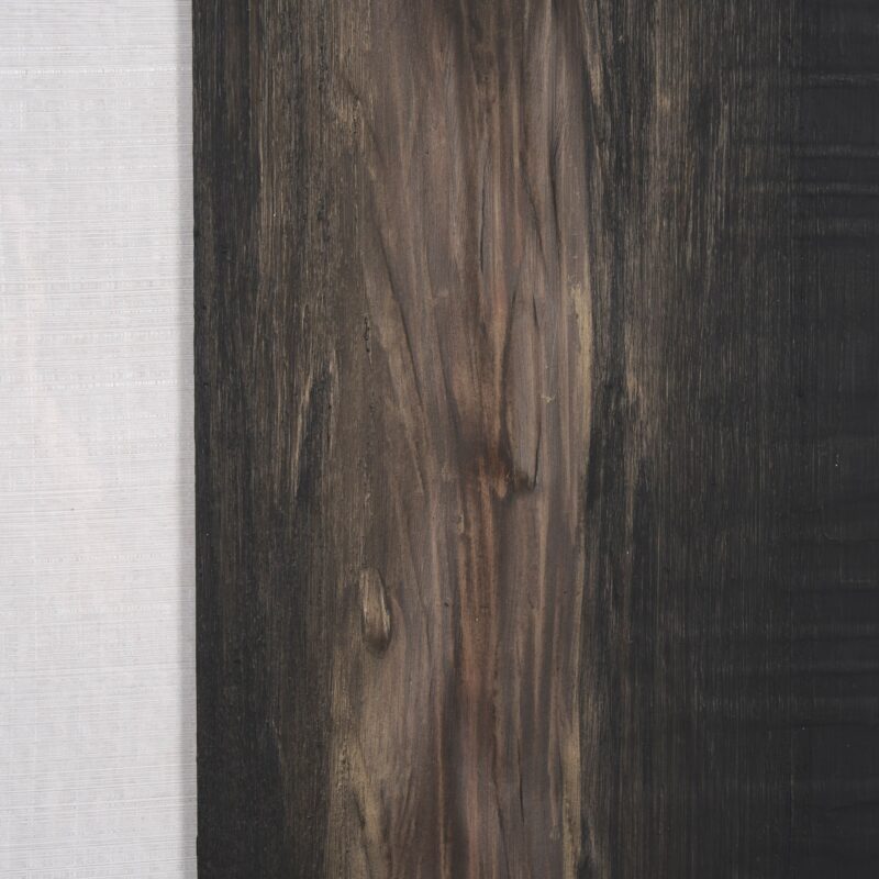 Contrasting textures of wood and fabric create a harmonious and sophisticated design composition.