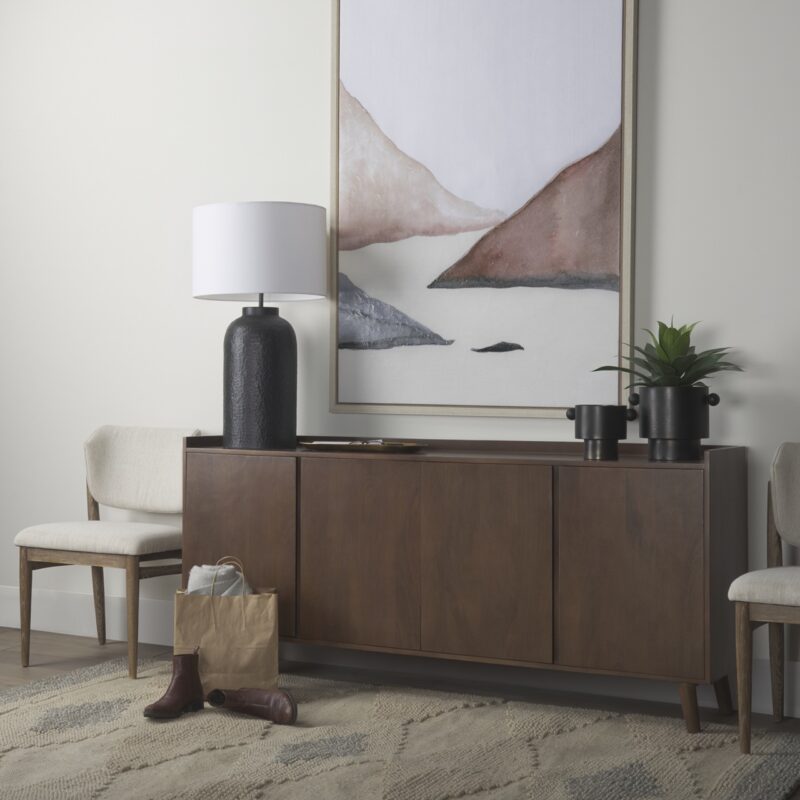 Stylish modern living room featuring a wooden sideboard, soft artwork, and inviting seating.