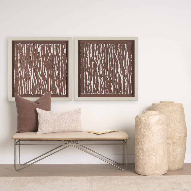 Warm minimalist interior featuring earthy accents, decorative pillows, and organic art.