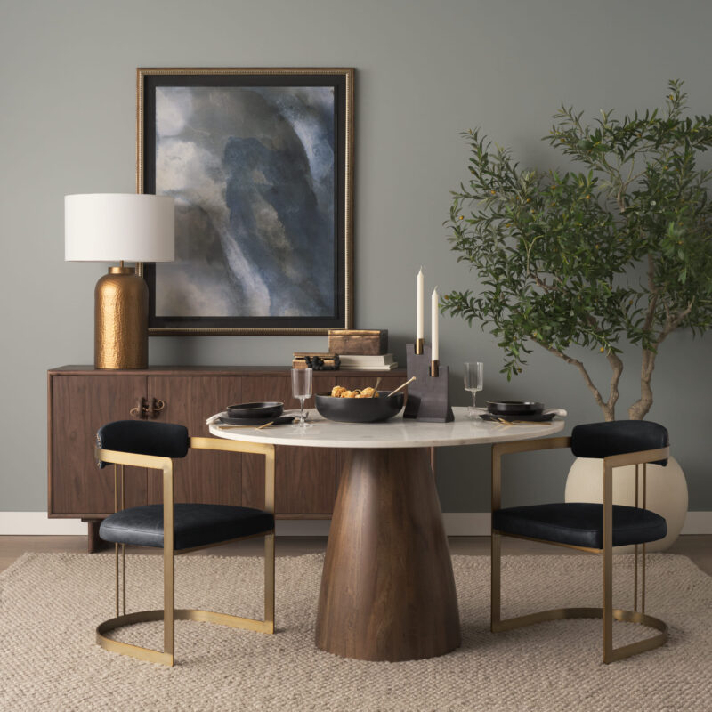 Elegant modern dining area featuring a marble table, stylish chairs, and artistic decor.