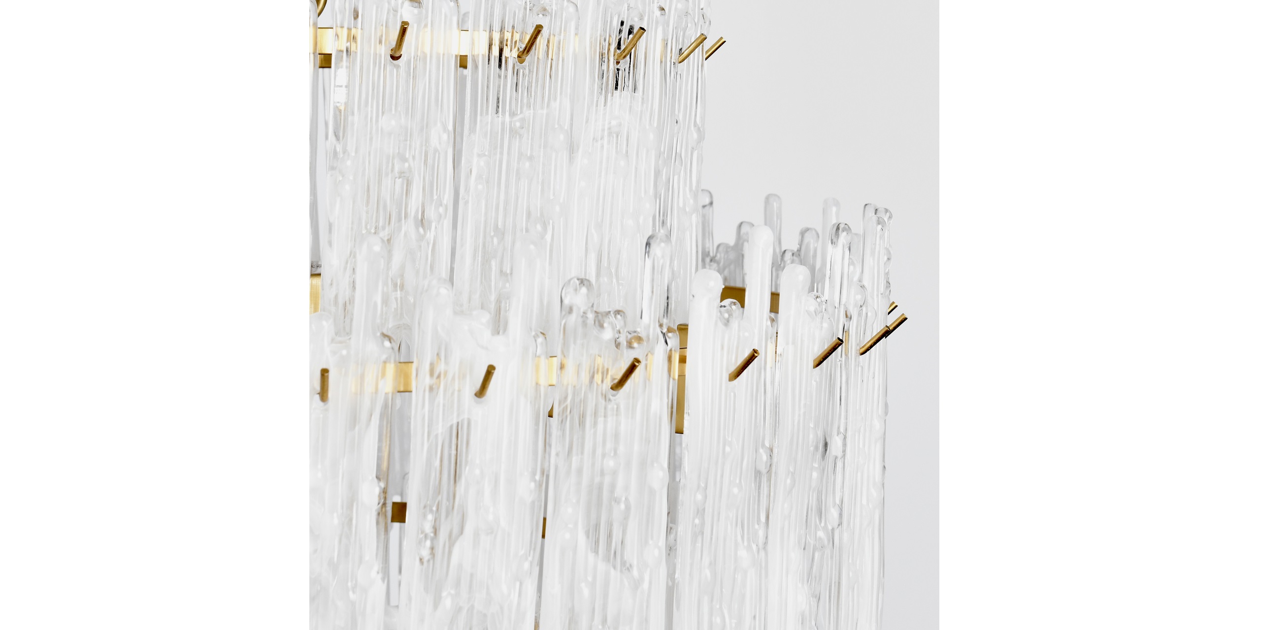Contemporary chandelier with cascading glass rods and elegant gold accents, perfect for modern interiors.