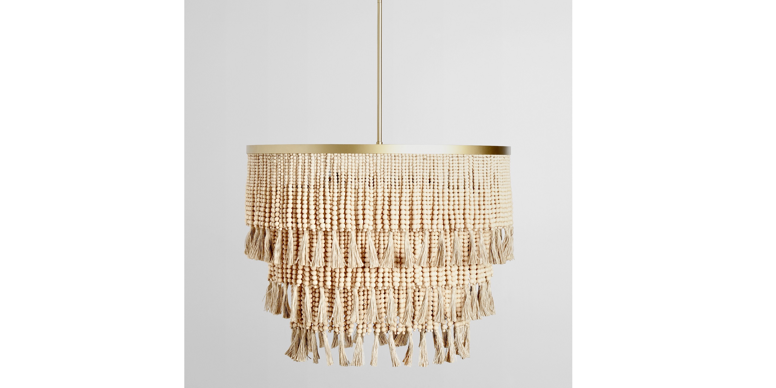 Modern bohemian chandelier with gold accents and layered fringe for a warm, inviting ambiance.