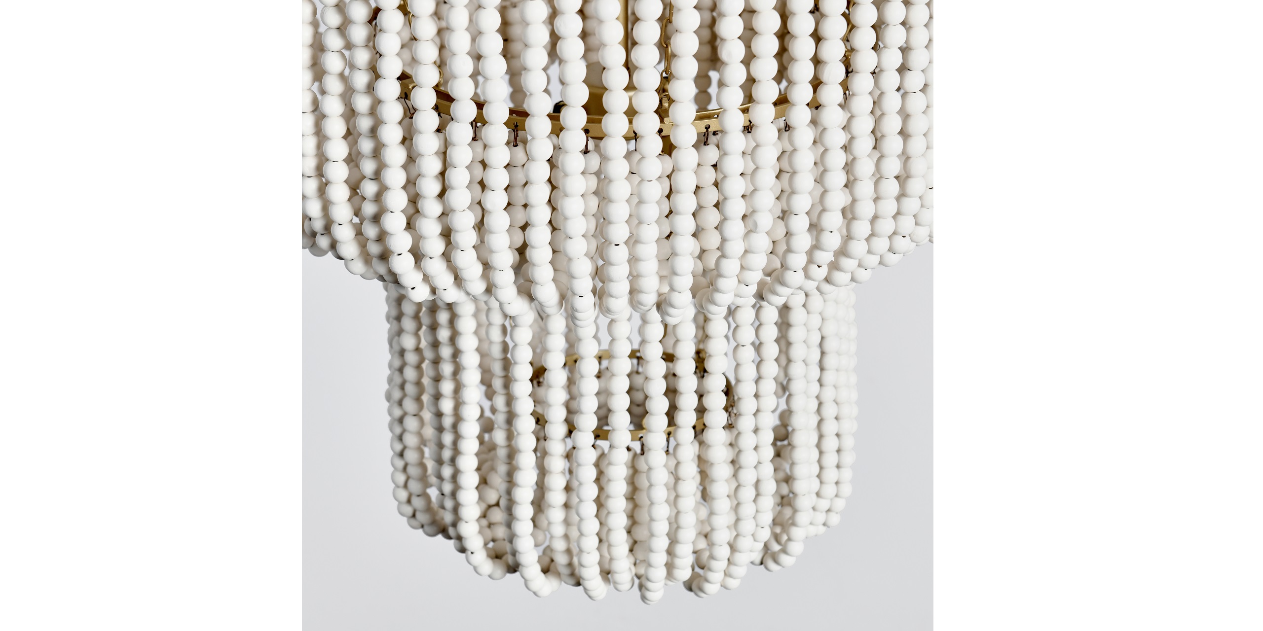 Elegant white bead chandelier with cascading strands, perfect for modern and contemporary interiors.