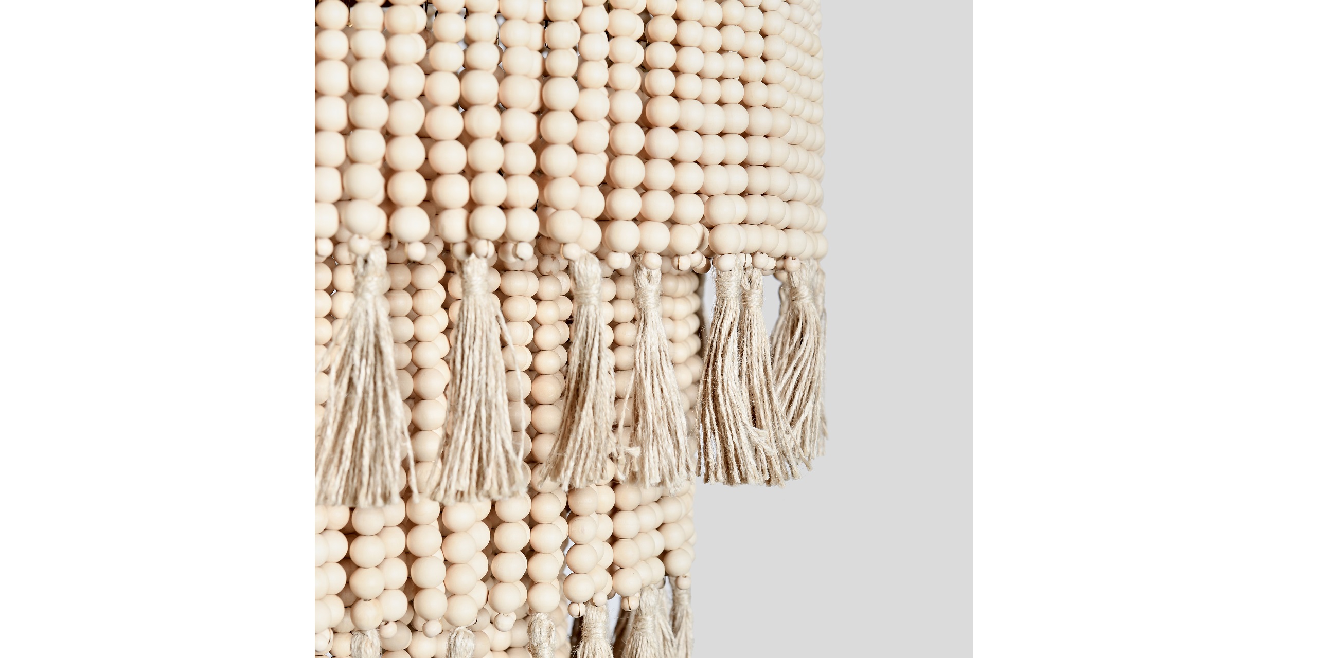 Elegant beige wooden beads with fringe tassels, perfect for bohemian or minimalist decor.