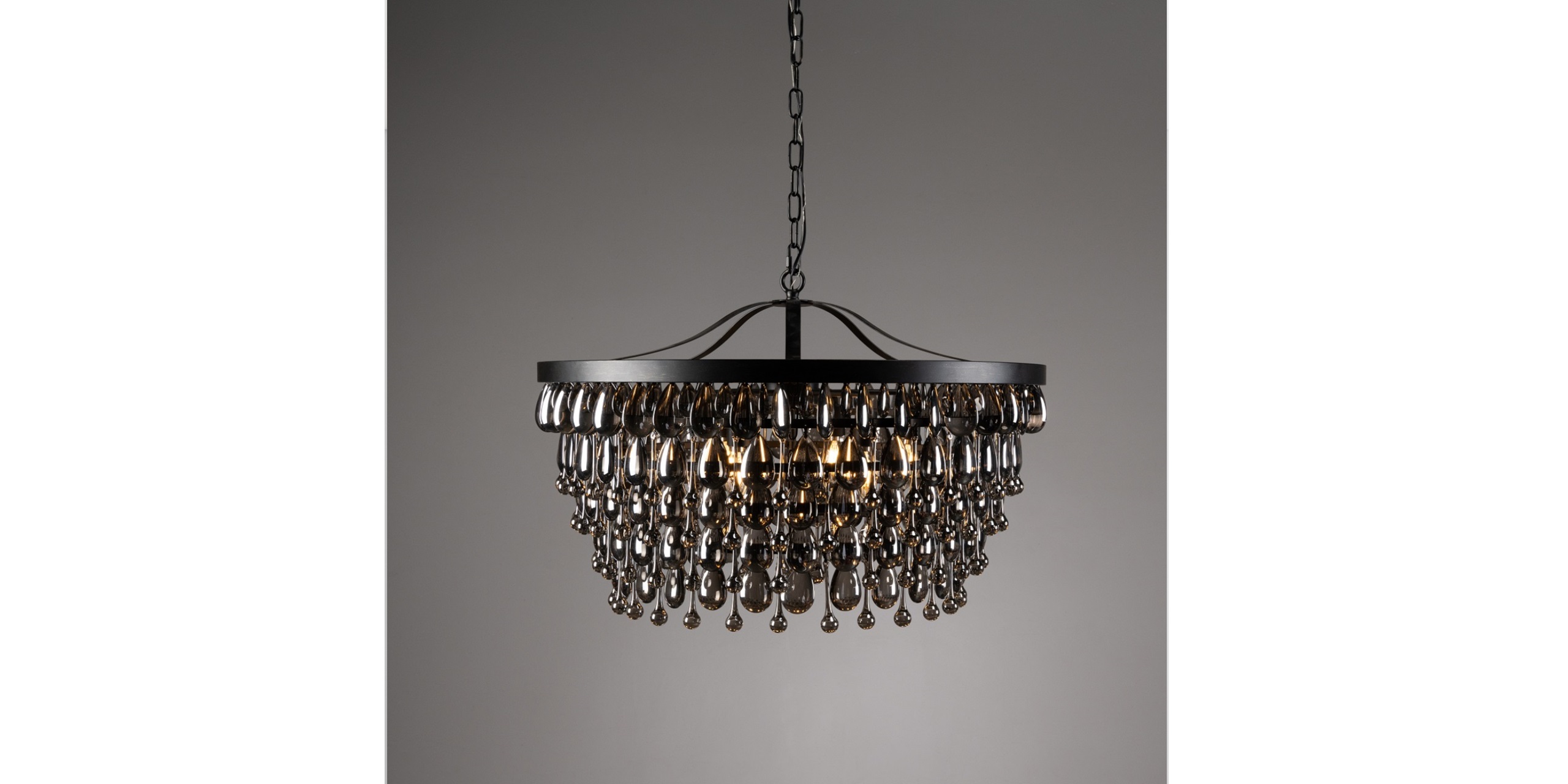 Elegant modern black chandelier with crystal drops, perfect for stylish dining and living spaces.