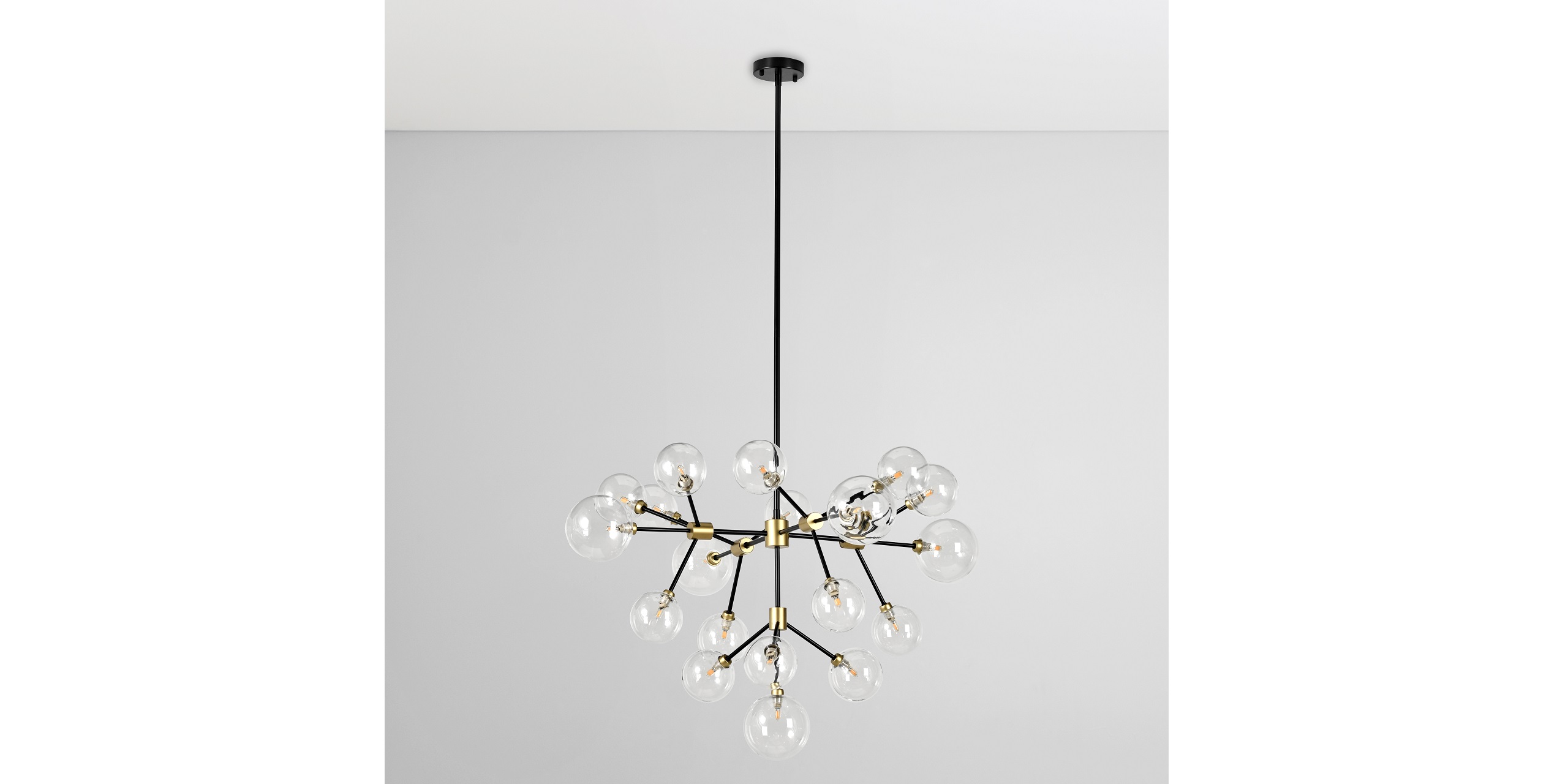 Modern chandelier with glass bulbs and brass accents, perfect for contemporary interior designs.