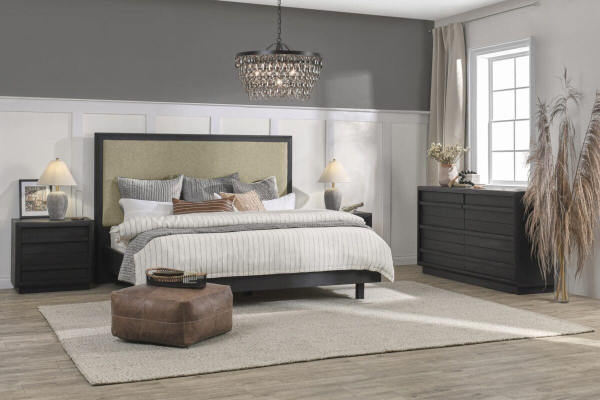 Elegant modern bedroom with cozy ambiance, featuring a green headboard, stylish nightstands, and sparkling chandelier.