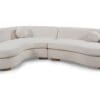 Elegant sectional sofa in light beige upholstery, featuring curvilinear design and comfortable throw pillows.
