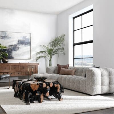 Cozy modern living room with natural wood accents, inviting sofa, and bright greenery.