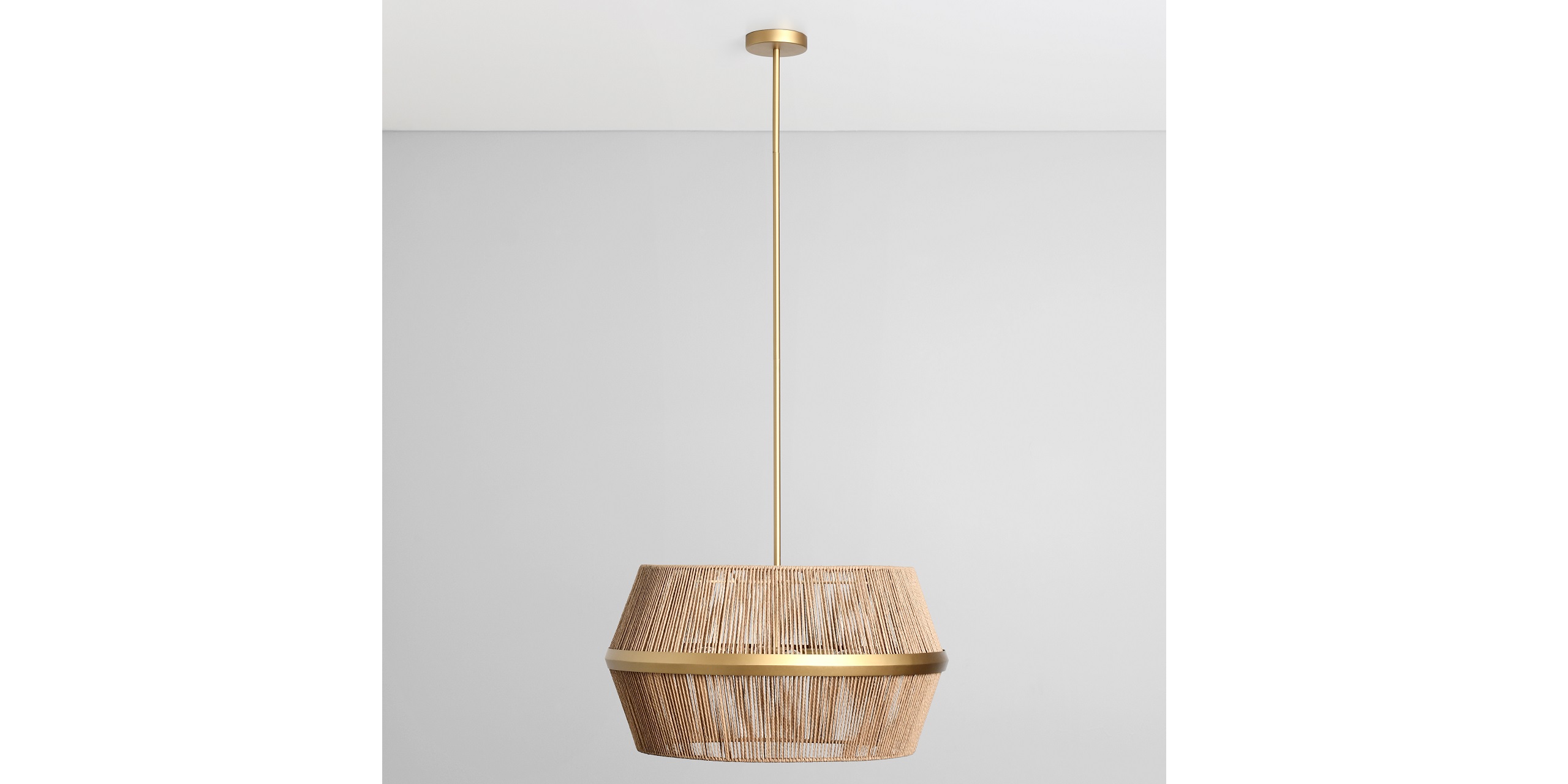 Stylish woven pendant light with gold accents, perfect for modern and organic interior designs.