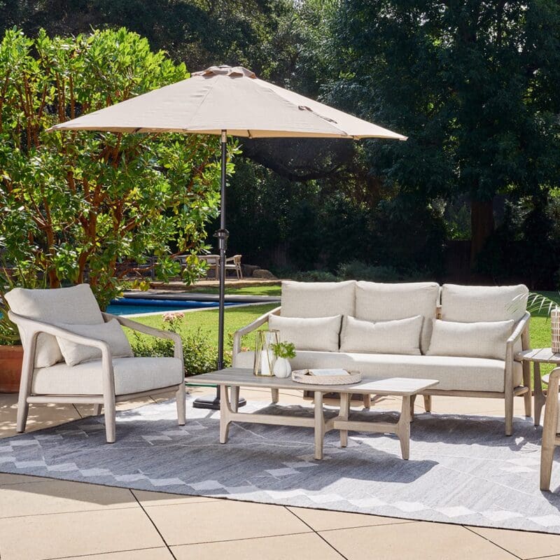 Stylish outdoor living area with shaded seating, lush greenery, and a welcoming atmosphere for relaxation.