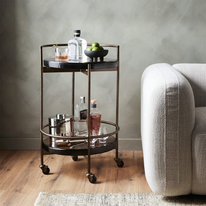Elegant two-tiered bar cart showcasing spirits and fresh limes, perfect for stylish entertaining.