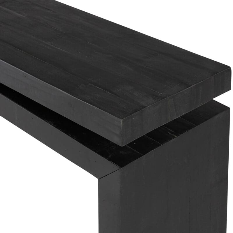 Sleek black minimalist bench with geometric lines, perfect for modern interiors and versatile use.
