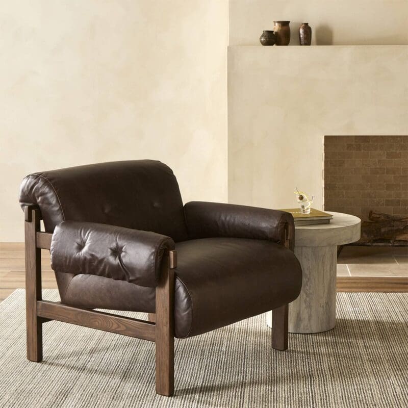 Contemporary living room with a stylish brown leather armchair and sleek marble side table.