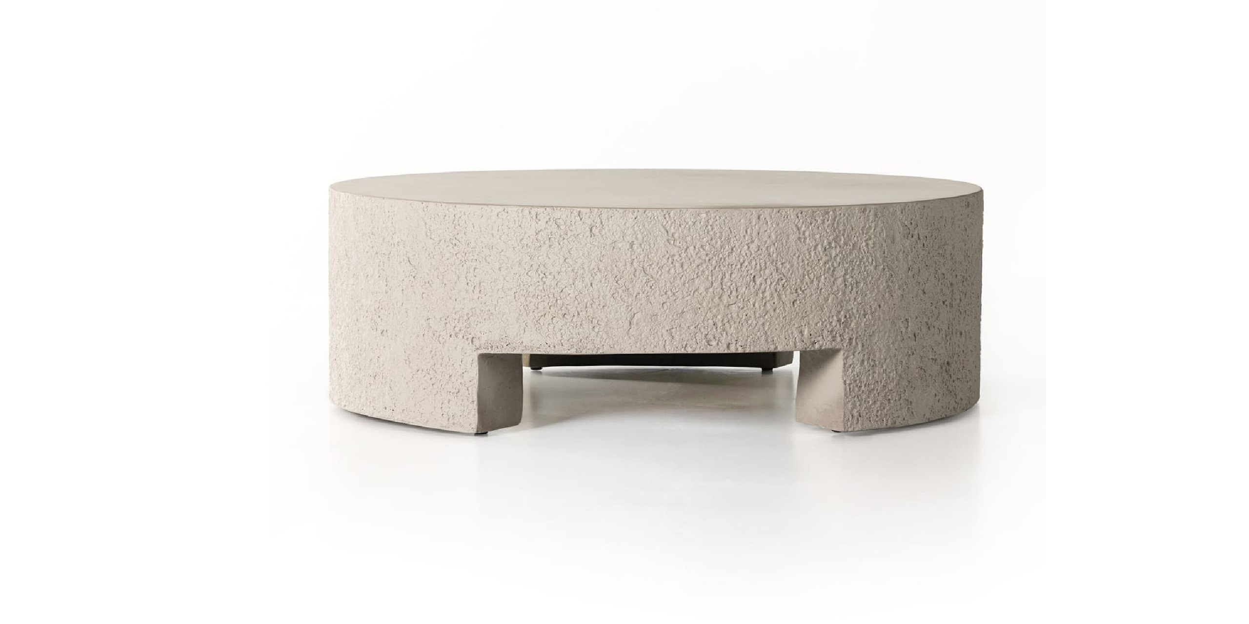 Unique circular concrete coffee table with a modern design and functional cut-out base.