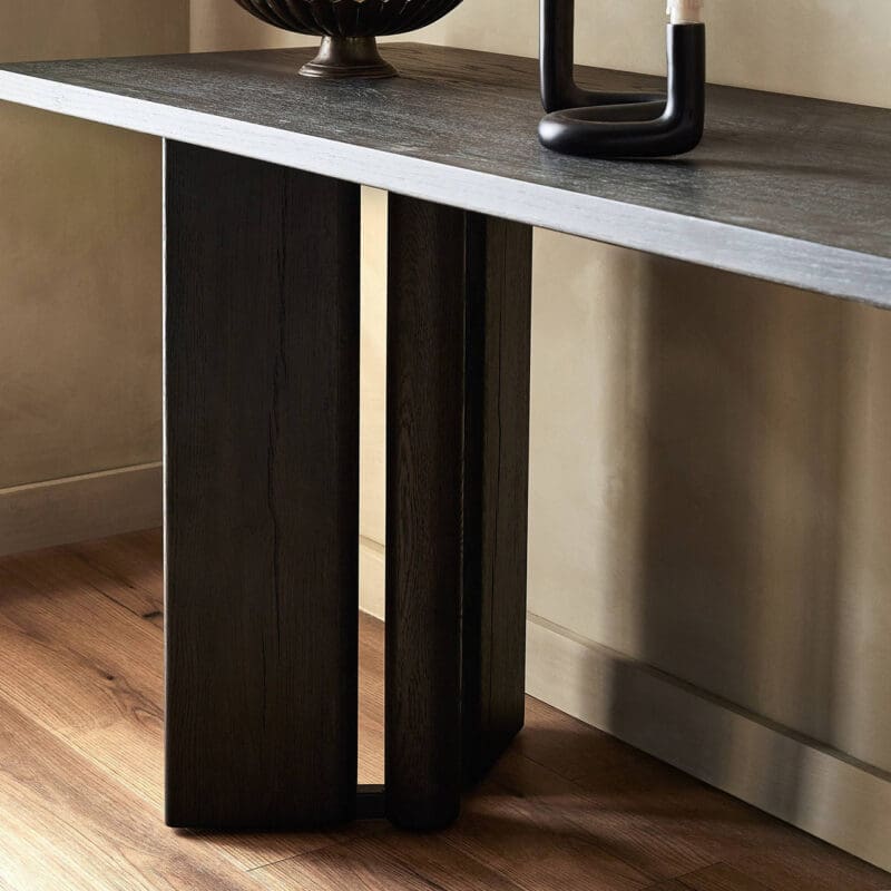 Contemporary gray console table with black wooden legs, adding elegance to any space.