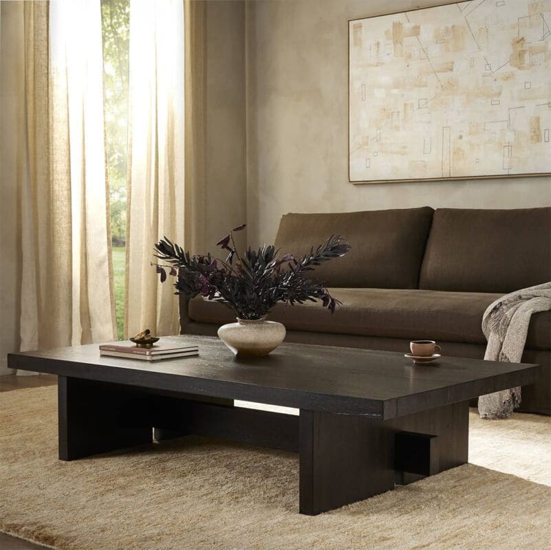 Inviting contemporary living room with a warm vibe, dark coffee table, and cozy sofa.