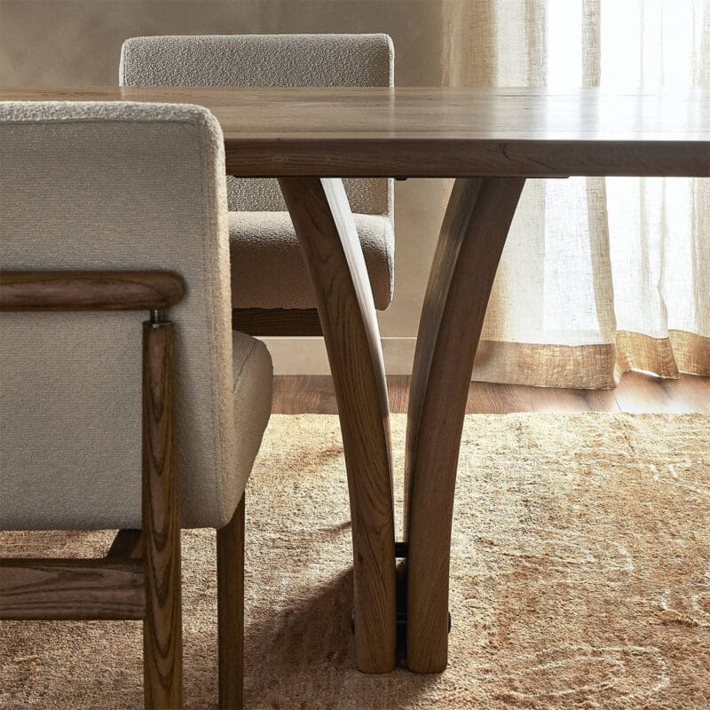Inviting dining area with polished wood table, plush chairs, and natural light ambiance.