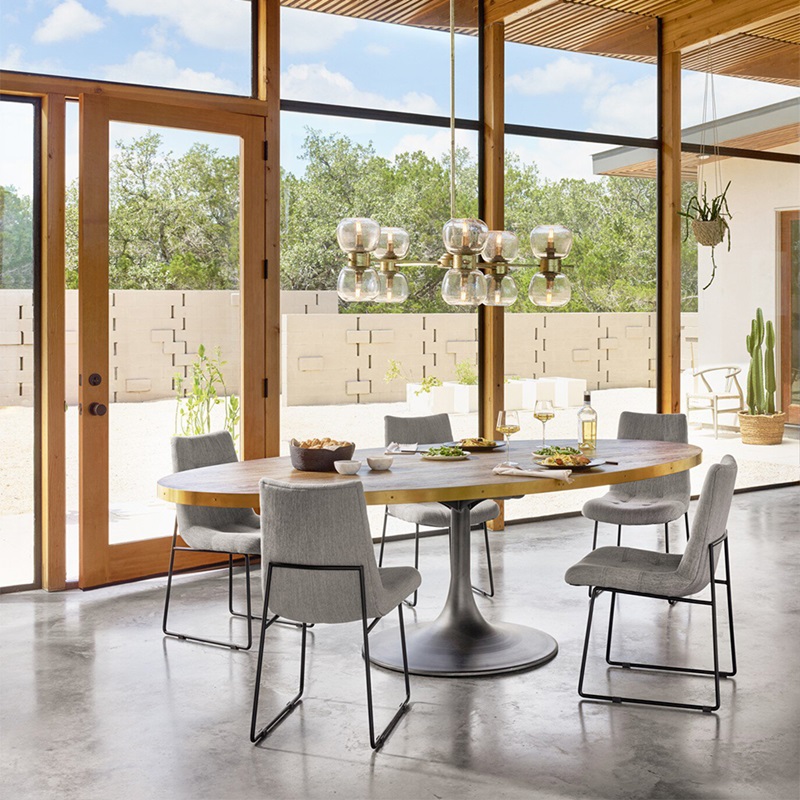 Contemporary dining space with glass doors, connecting to a tranquil garden, and elegant furnishings.
