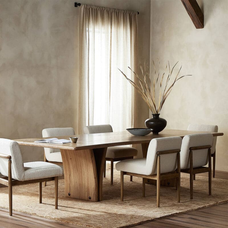 Elegant dining room with wooden table, neutral chairs, and natural light creating a cozy atmosphere.