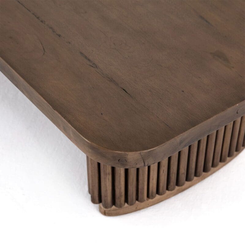 Stylish contemporary coffee table with a dark wood top and textured groove base.