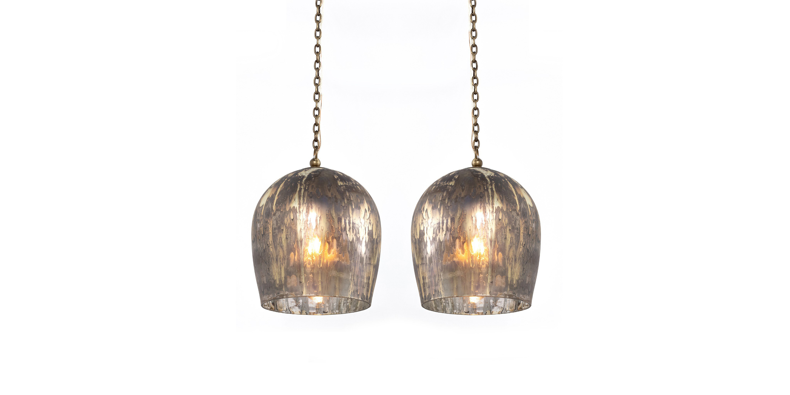 Elegant vintage pendant lamps with ribbed glass shades and brass chains, perfect for any decor.