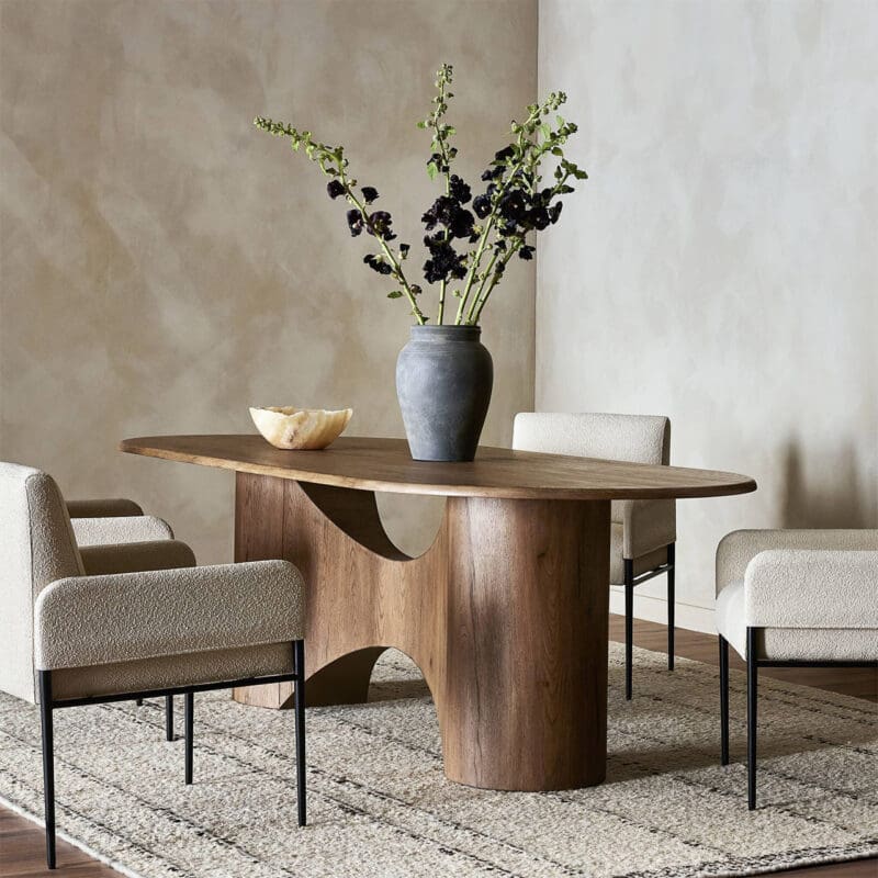 Stylish dining area with unique wood table, elegant chairs, and sophisticated floral centerpiece.