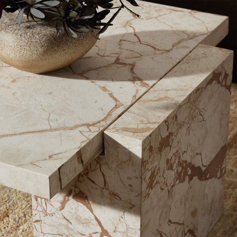 Stylish marble coffee table with succulents in a cozy, elegant living room setting.