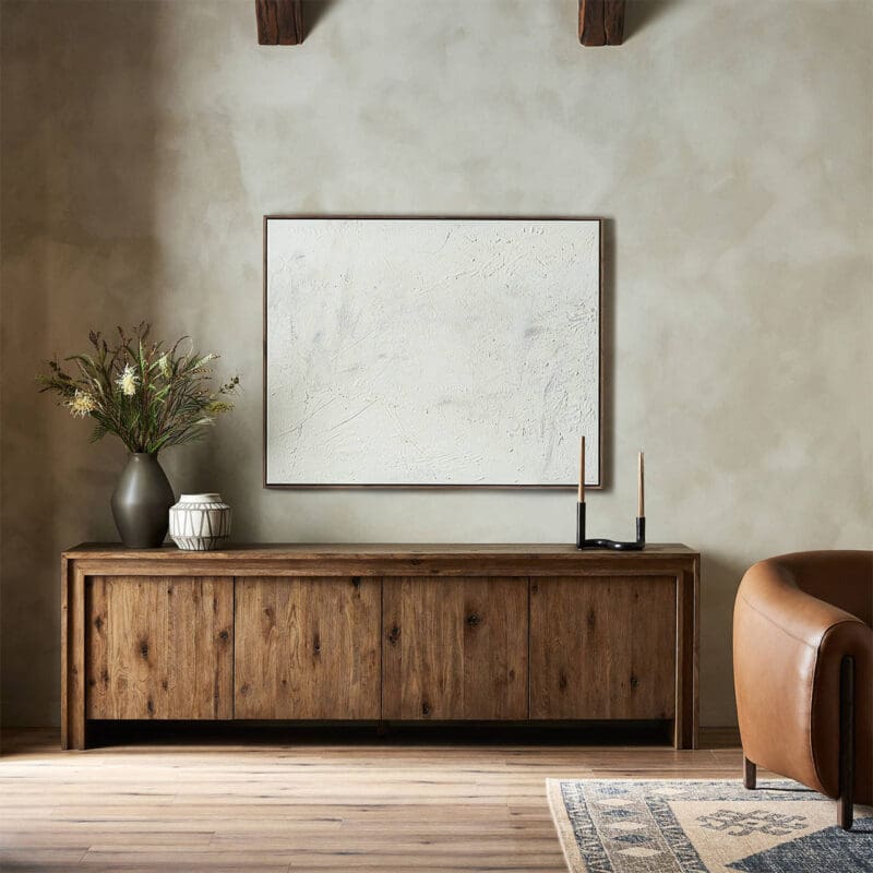 Tranquil modern interior with rustic console table, abstract art, and cozy leather armchair.