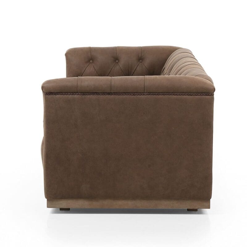 Chic brown couch with tufted backrest and rounded arms, perfect for modern living spaces.