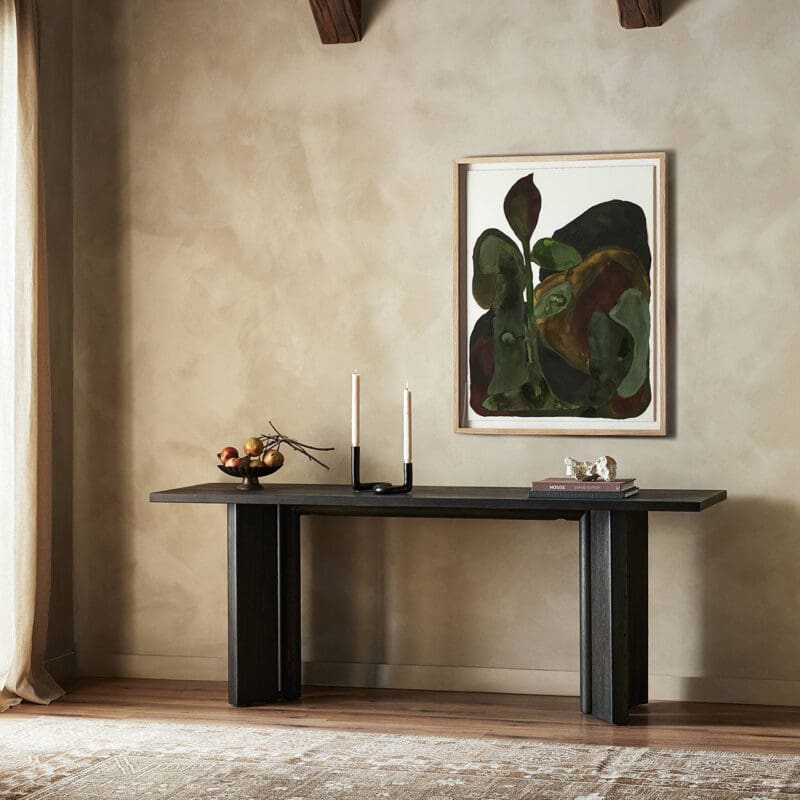 Sleek dark wood console table with abstract art in a cozy, inviting interior space.