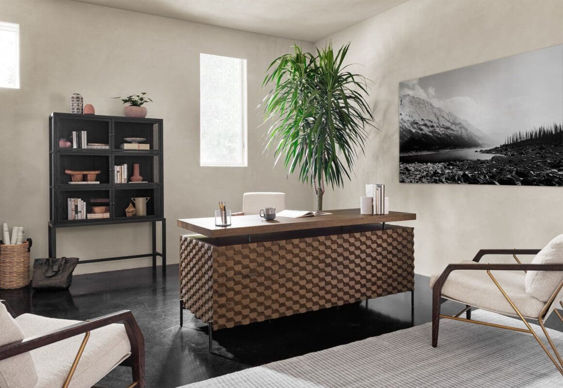 Chic office space with geometric desk, cozy seating, and natural light for productivity and comfort.