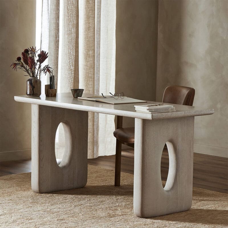 Sleek modern desk with organic design in a cozy, inviting workspace with natural light.