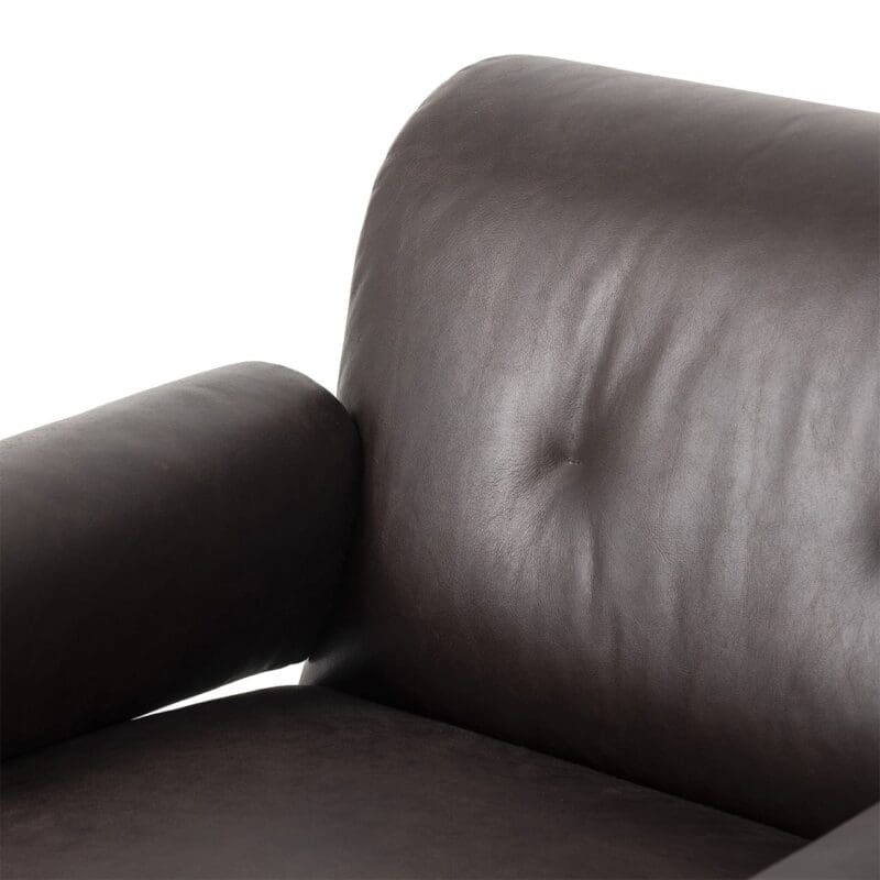 Contemporary dark brown leather armchair with plush backrest and classic button tuft for stylish comfort.