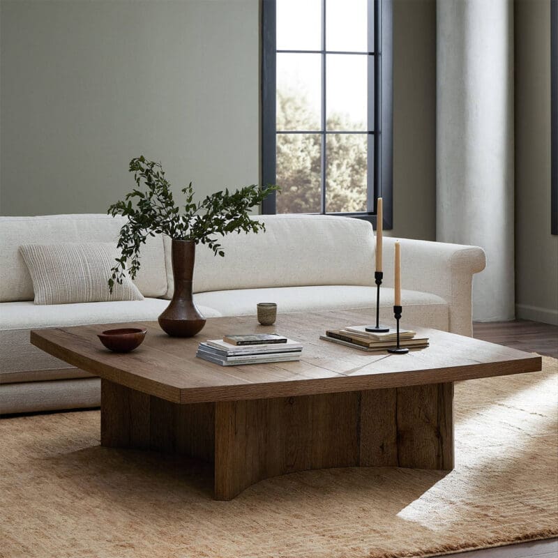 Modern living room featuring unique wooden coffee table, cream sofa, and stylish decor accents.
