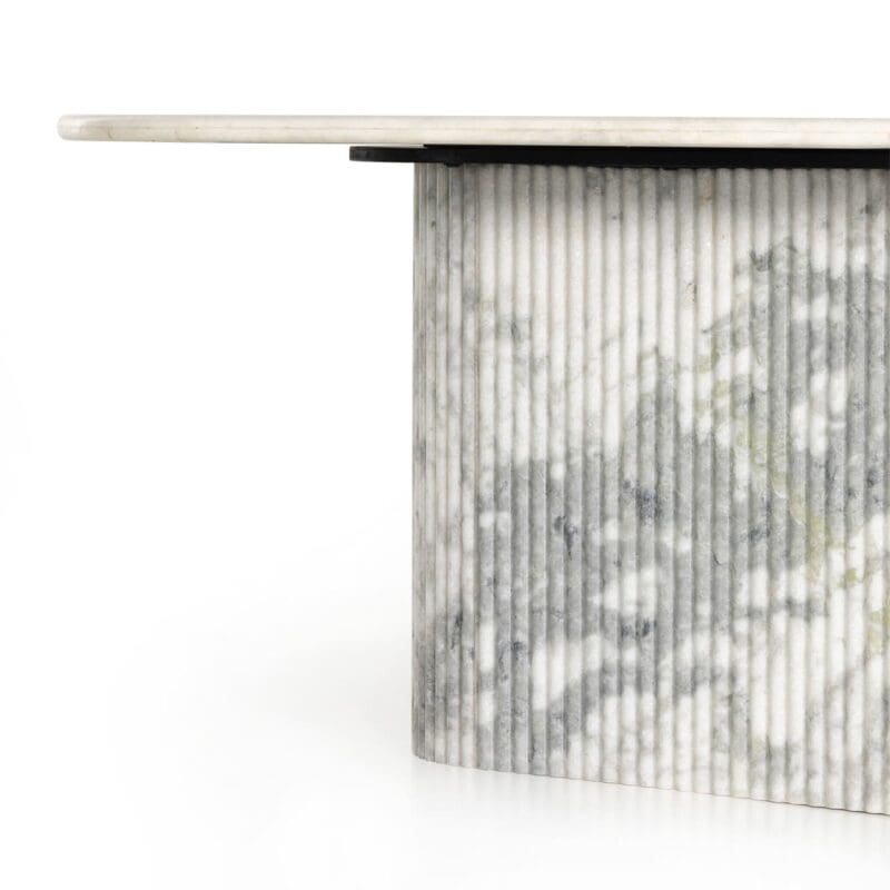 Contemporary marble table with sleek top and textured base for a striking focal point.