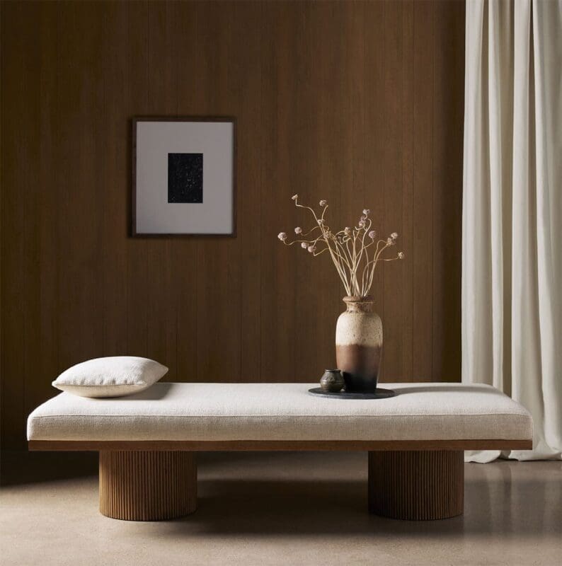 Serene minimalist interior featuring a cozy bench, terracotta vase, and warm wooden accents.