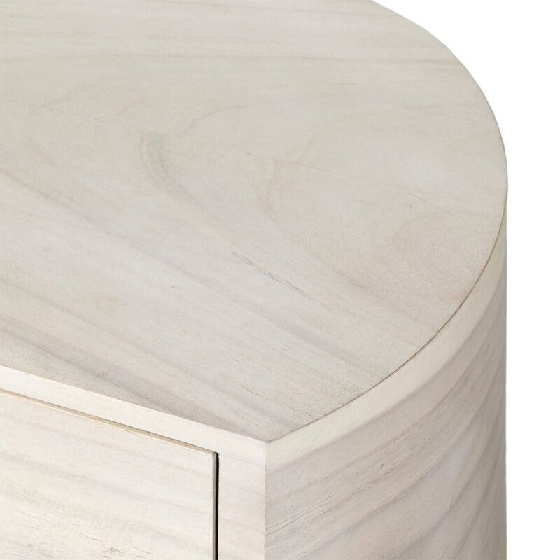 Contemporary rounded side table in warm beige, blending style and functionality for modern interiors.