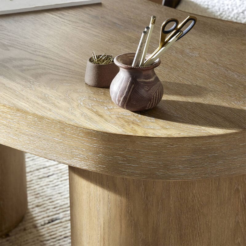 Stylish wooden table with terracotta pot and writing tools enhances inviting workspace aesthetic.