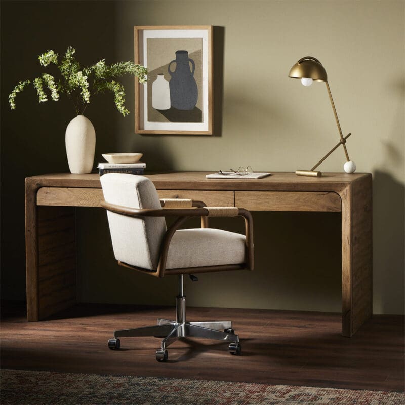 Chic wooden desk workspace with green accents, modern art, and vibrant foliage for inspiration.