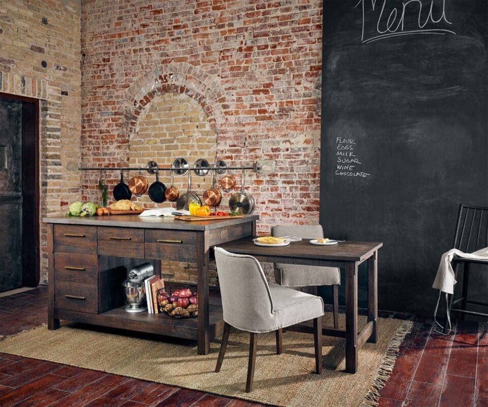 Charming rustic kitchen with exposed brick, a wood island, and cozy dining area for meals.