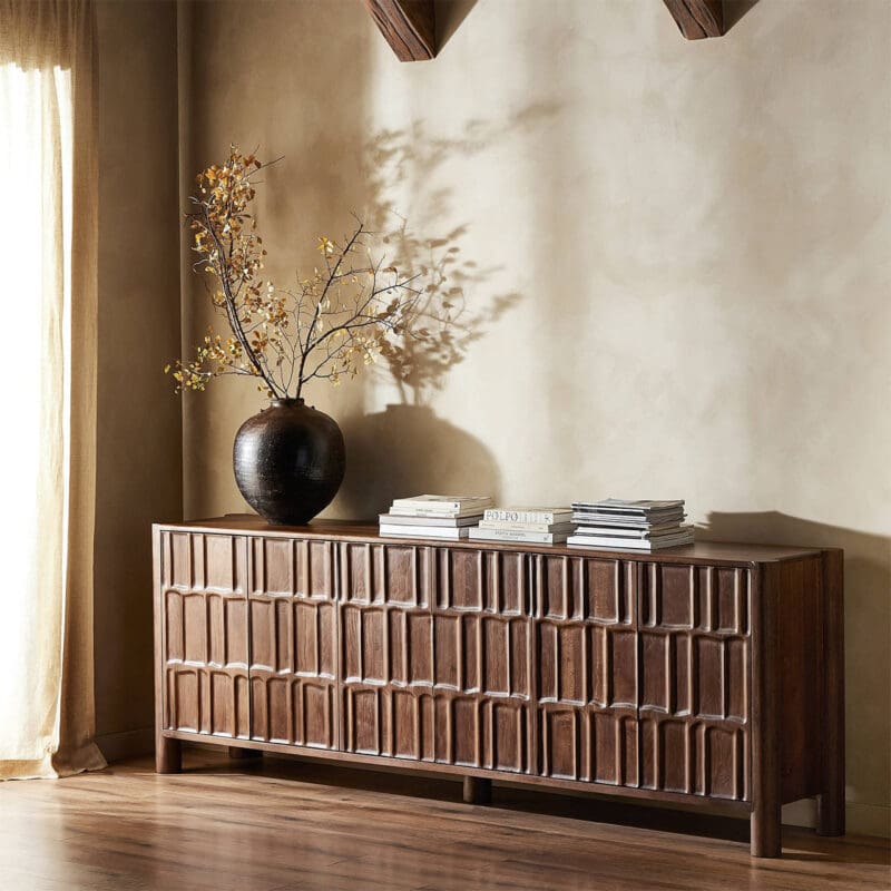Elegant dark wood sideboard and glossy vase create a cozy, stylish interior ambiance.
