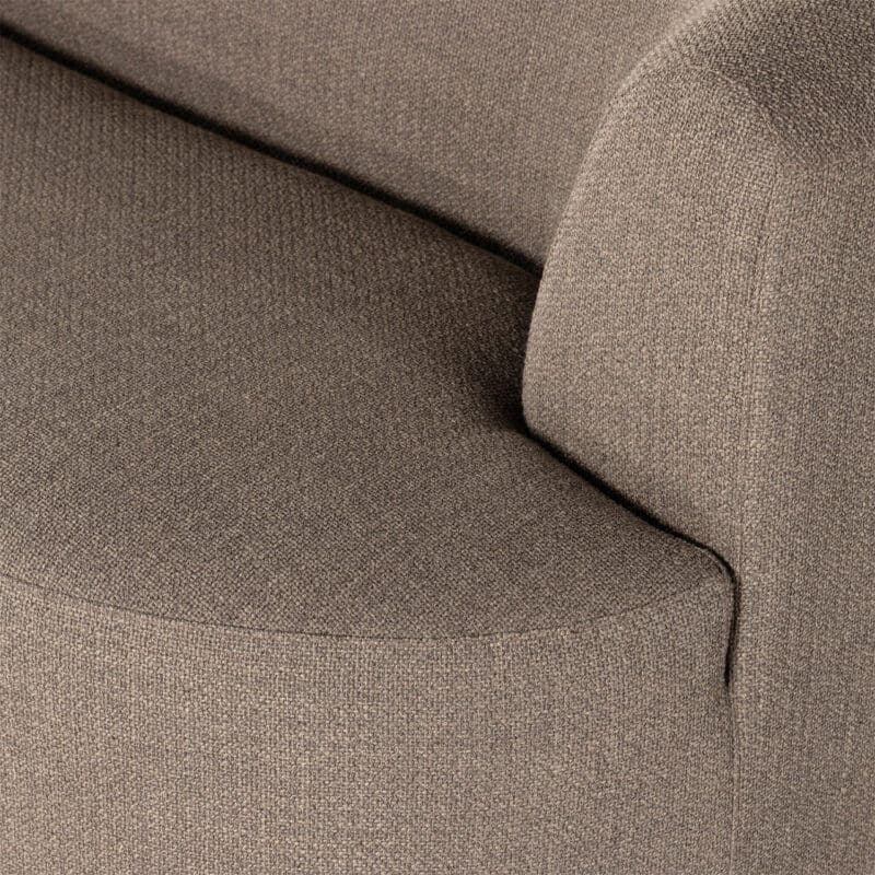 Cozy light brown sofa with modern curves, perfect for any decor style.
